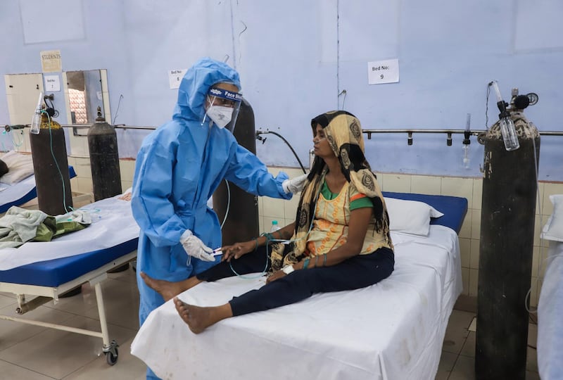 A nurse attends to a patient at a free Covid-19 care centre being operated by a Sikh voluntary organisation in Ghaziabad, on the outskirts of New Delhi. AP Photo