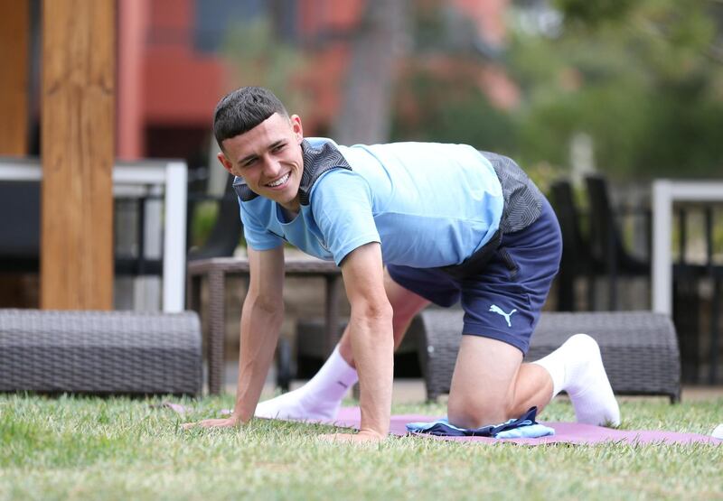 LISBON, PORTUGAL - AUGUST 11: Phil Foden of Manchester City takes part in a stretching session in the build up to the UEFA Champions League Quarter Final match at the team hotel on August 11, 2020 in Lisbon, Portugal. (Photo by Victoria Haydn/Manchester City FC via Getty Images)