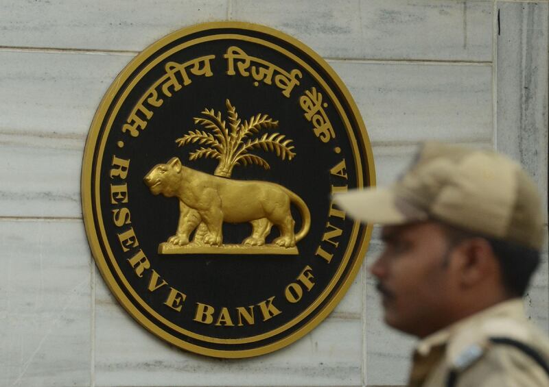 An Indian security guard stands at the entrance of the Reserve Bank of India (RBI) head office in Mumbai on December 6, 2017.
India's central bank held interest rates at a seven-year low on December 6, citing concerns over inflation and rising oil prices as a reason not to make a further cut. / AFP PHOTO / PUNIT PARANJPE