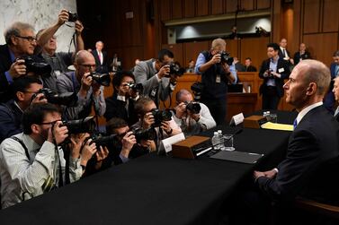 Boeing chief executive Dennis Muilenburg, right, sits before the start of a Senate Committee hearing on the company's 737 Max and aviation safety on Tuesday. AP Photo