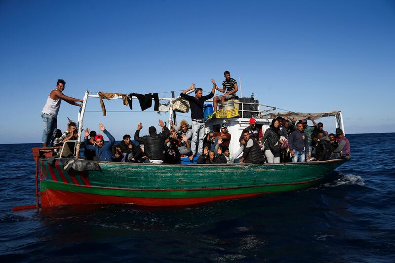 epa06294596 A boat carrying 48 migrants near the Portuguese Navy  Viana do Castelo Oceanic Patrol Ship, off the coast of Pozzallo, Sicily, Italy, 27 October 2017, (issued 28 October 2017). Reports state that 48 migrants were rescued on 27 October 2017 by the Portuguese Navy in the Mediterranean landed in Pozzallo on 28 October 2017 and were handed over to the Italian authorities 19 hours after being picked up from a vessel at risk of fire.  EPA/JOSE SENA GOULAO
