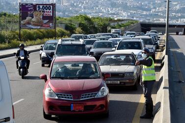 Lebanese policemen check vehicles at a highway checkpoint in Ouzai area south of Beirut, Lebanon. EPA/WAEL HAMZEH