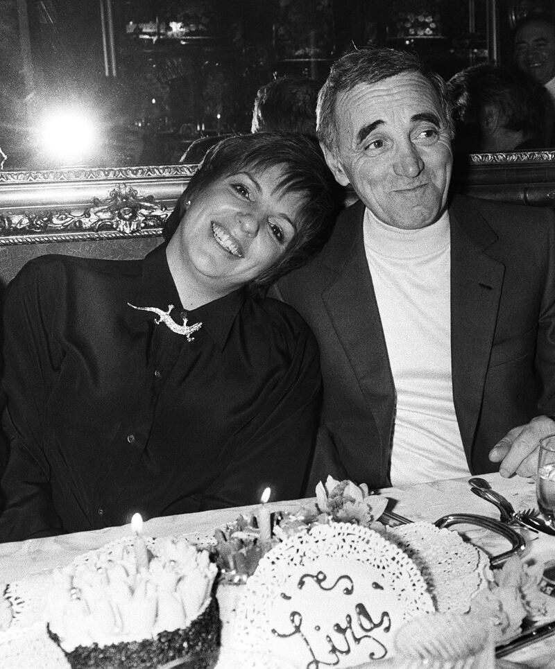 Charles Aznavour chats with US actress and singer Liza Minnelli prior to a dinner at a restaurant, in Paris AFP