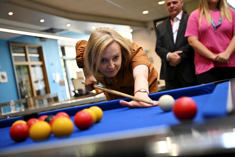Liz Truss plays pool during a visit to the Onside Future Youth Zone in London. Reuters