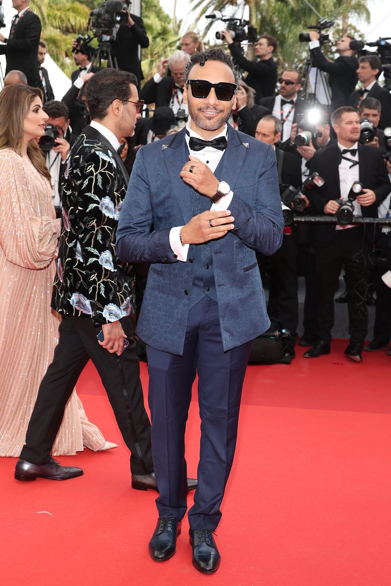 French actor Yassine Azzouz wears midnight blue, three-piece suit. Getty
