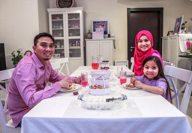 Abu Dhabi, U.A.E., May 29, 2018.  Images people of different nationalities and backgrounds at iftar time to show the type of food they eat, for a series on international iftar. This family is from Malaysia.  Azura Yunos with her husband Mudzaffa Reza and their daughter Mishel (5).
Victor Besa / The National
Reporter:  Hala Khalaf
Section:  Arts & Life