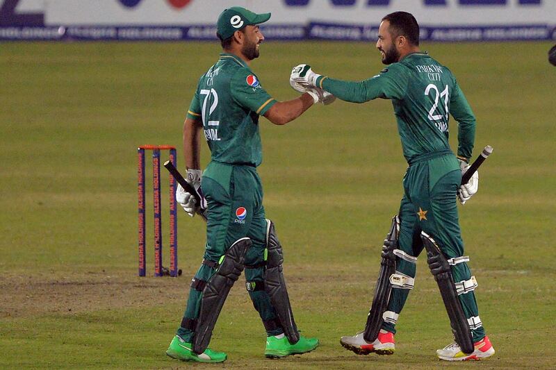 Pakistan's Mohammad Nawaz (R) greets Khushdil Shah after winning the third Twenty20 cricket match between Bangladesh and Pakistan at Sher-E-Bangla National Cricket Stadium in Dhaka on November 22, 2021.  (Photo by Munir Uz zaman  /  AFP)