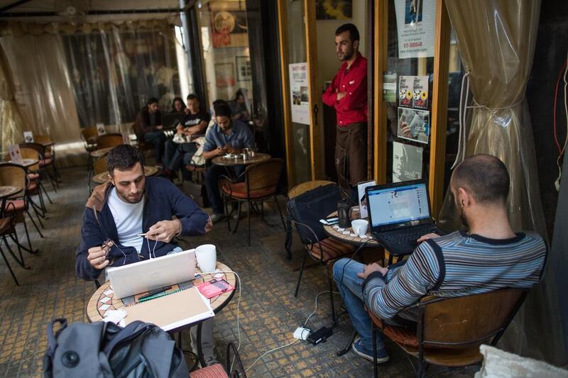 The UAE announced on Tuesday it was banning citizens from travelling to Lebanon and reducing its diplomatic staff in the country. Here, young people sit in a Beirut cafe.  Andrew McConnell for The National