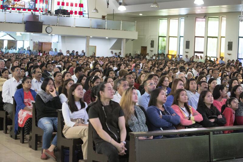 DUBAI, UNITED ARAB EMIRATES - Worshippers listening to the mass  by  Pope  Francis on the screen at St. Mary's Church, Oud Mehta.  Leslie Pableo for The National for Ramolas story