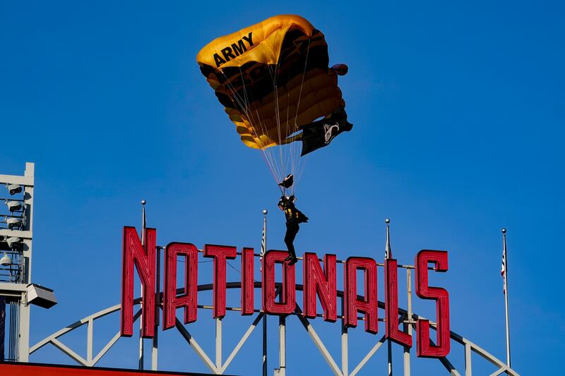 A member of the US Army parachute team the Golden Knights descends into National Park in Washington on April 20. AP