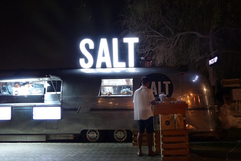 ABU DHABI, UNITED ARAB EMIRATES - - -  July 10, 2015 --- The Salt food truck is parked in Mushrif Park where people can drop by for the late night munchies. They also provide amble outdoor seating with misting fans. During Ramadan, howerver its slow and picks up around 11pm to 2am where they serve up there popular burgers and other food items.    ( DELORES JOHNSON / The National )  *** Reporter is not listed **** *** Local Caption ***  DJ-100714-NA-SALT-004.jpg