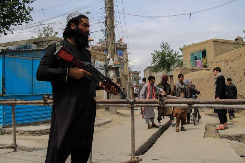 Taliban stand guard in an area surrounding a Kabul school in the aftermath of multiple bomb blasts in April 2022. EPA