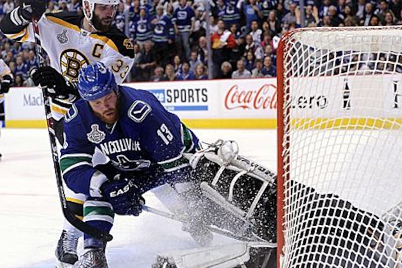 Raffi Torres, front, was unemployed in the summer, but the Vancouver Canucks decided to take a chance on him. He scored the last minute winner in Game 1 of the Stanley Cup Finals.