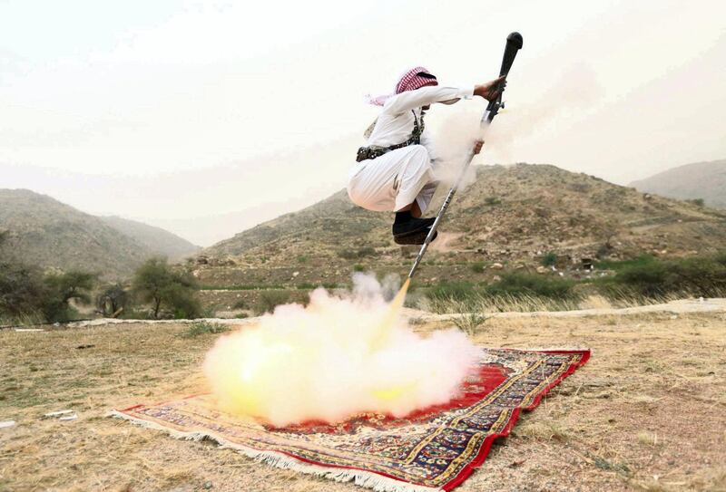 A man fires a weapon as he dances during a traditional excursion near the western Saudi city of Taif, August 8, 2015. Saudis usually party in such excursions as they celebrate weddings or graduations. REUTERS/Mohamed Al Hwaity      TPX IMAGES OF THE DAY    
FOR BEST QUALITY IMAGE ALSO SEE: GF10000171403 - GF20000017914