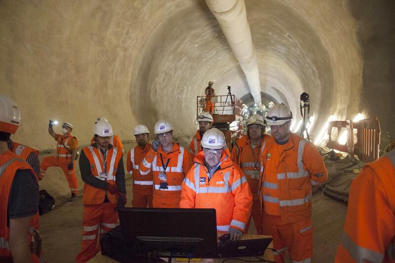 Crossrail workers wait as a tunneling machine breaks through into the Whitechapel station on April 4, 2014 in London. The breakthrough marked completion of 75 per cent of the tunnelling work, which will be finished in 2018. Dan Kitwood / Getty Images