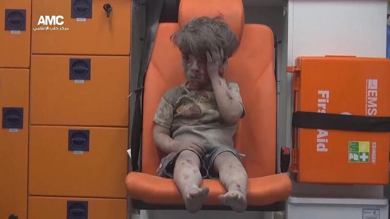 Omar Daqneesh  sits in an ambulance after an airstrike hit a house in Aleppo. EPA