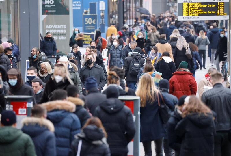 People with protective face masks walk at Tauentzienstrasse shopping boulevard, amid the coronavirus disease (COVID-19) outbreak in Berlin, Germany, December 5, 2020.    REUTERS/Fabrizio Bensch