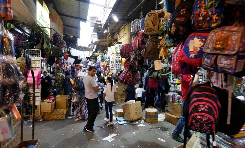 Parents shop for school uniforms for their children, three days ahead of the start of the new academic year in Damascus, Syria.  EPA