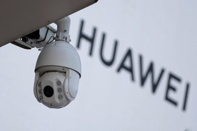 FILE PHOTO: A surveillance camera is seen next to a sign of Huawei outside a shopping mall in Beijing, China January 29, 2019. REUTERS/Jason Lee/File Photo