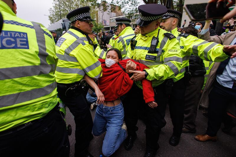 Police officers make arrests after demonstrators formed a blockade around a coach that was due to transport asylum seekers from a hotel in Peckham, south London, to the Bibby Stockholm barge in Dorset. EPA