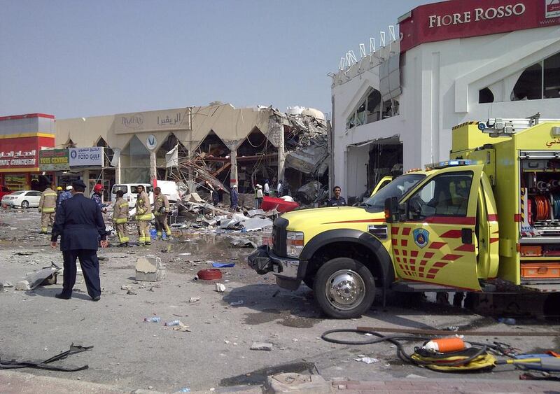 Qatari emergency personnel inspect the site of a what state television said was a “gas cylinder” explosion in the Gulf emirate’s capital Doha on February 27, 2014. The explosion, which killed and wounded more than a dozen people, tore through a restaurant attached to a mall in Doha, according to Qatari Television, which said it could not be immediately clear if the blast was accidental. Victoria Baux / AFP 