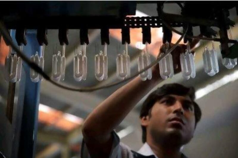 A worker checks burners at the Starlite Lighting Ltd factory in Nasik, Maharashtra state, India. Indian manufacturing growth slowed in May, a survey showed, adding to signs of weakening demand after economic expansion moderated to a nine-year low.