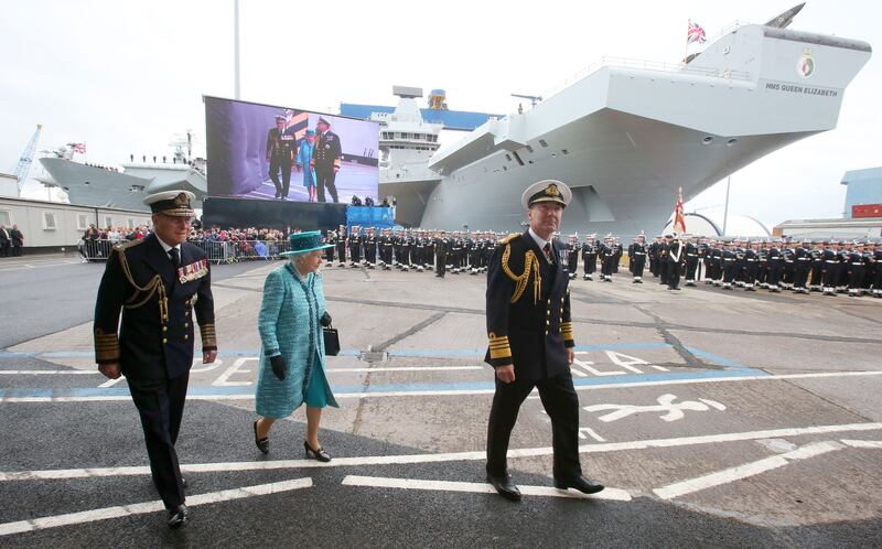 The queen and Prince Philip arrive at 'HMS Queen Elizabeth' in Rosyth Dockyard in Fife, where she formally named the Royal Navy's biggest ever ship in 2014.