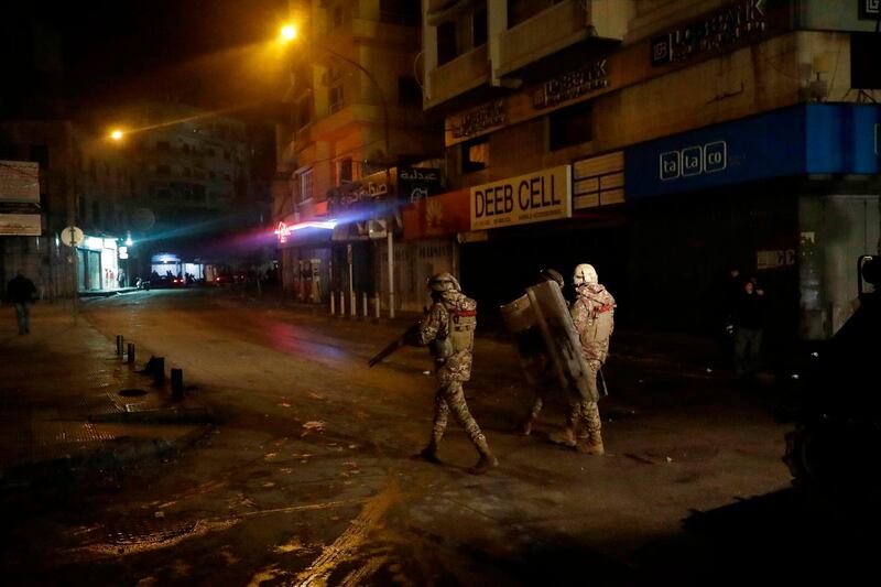 Lebanese security forces advance during clashes with anti-government protesters in the northern city of Tripoli, on January 29, 2021.AFP