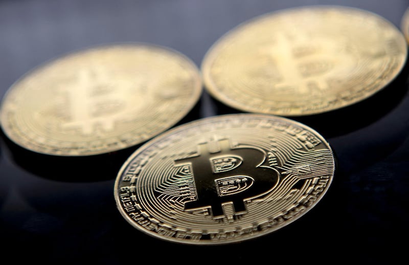 (FILES) This file photo taken on November 20, 2017 shows gold plated souvenir Bitcoin coins arranged for a photograph in London.  Bitcoin plunged below 39,000 USD for the first time in more than three months on May 19, 2021 after China said cryptocurrencies would not be allowed in transactions and warned investors against speculative trading in them, despite the country powering most of the world's mining. / AFP / Justin TALLIS
