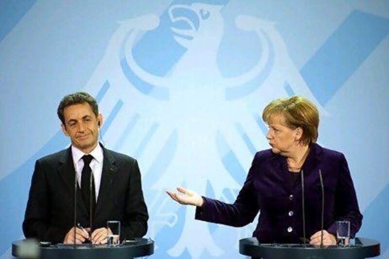 Nicolas Sarkozy, the French president, and Angela Merkel, the German chancellor, address a news conference in Berlin yesterday. Odd Andersen / AFP