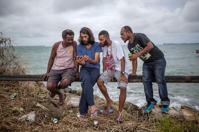 MANUS, LORENGAU, PAPUA NEW GUINEA - 2018/02/08: Asylum seekers Behrouz Boochani shows images from from his home town in Iranian Kurdistan for the locals at Manus island.

The human cost of Australias offshore detention policy has been high for those unfortunate enough to have been caught in its net. For asylum seekers trapped on the remote island of Manus in Papua New Guinea, the future remains as uncertain as ever. Australias offshore detention center there was destroyed in 31 October 2017 but for the 600 or so migrants who remain on the remote Pacific island, little has changed. The asylum seekers live with the torment of separation from family and friends and in the shadow of depression and the traumas of their past. (Photo by Jonas Gratzer/LightRocket via Getty Images)