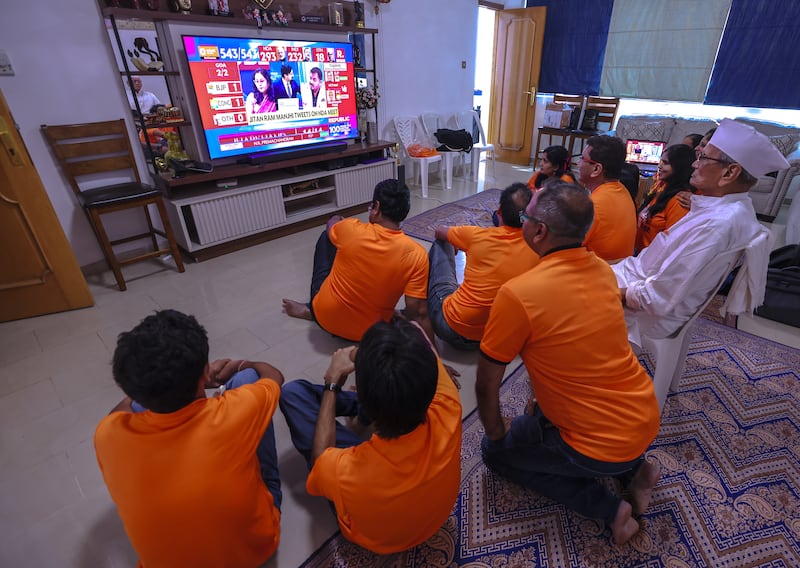 BJP supporters in Abu Dhabi watch the Indian general election. Victor Besa / The National