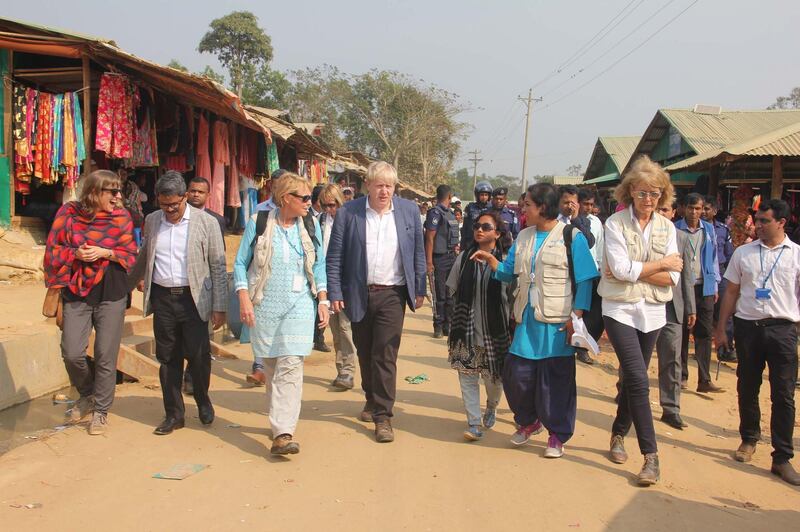 British Foreign Secretary Boris Johnson (C) walks inside a Rohingya refugees camp in Bangladesh's Cox's Bazar district on February 10, 2018.
Johnson visited camps for Rohingya refugees who have fled from Myanmar, on his second day of a two-day visit to Bangladesh. / AFP PHOTO / -