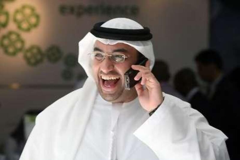 A local man laughing while on a mobile phone during the third day of Gitex Technology Week, held at the Dubai International Convention and Exhibition Centre.