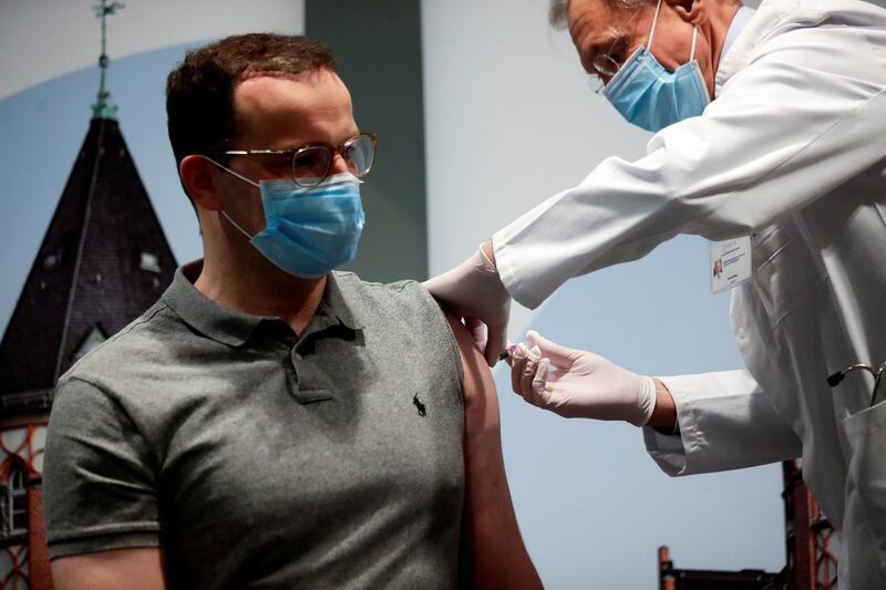 FILE PHOTO: German Health Minister Jens Spahn receives an influenza injection from doctor Harald Bias at Charite hospital, during the spread of the coronavirus disease (COVID-19), in Berlin, Germany, October 14, 2020. REUTERS/Hannibal Hanschke/Pool/File Photo