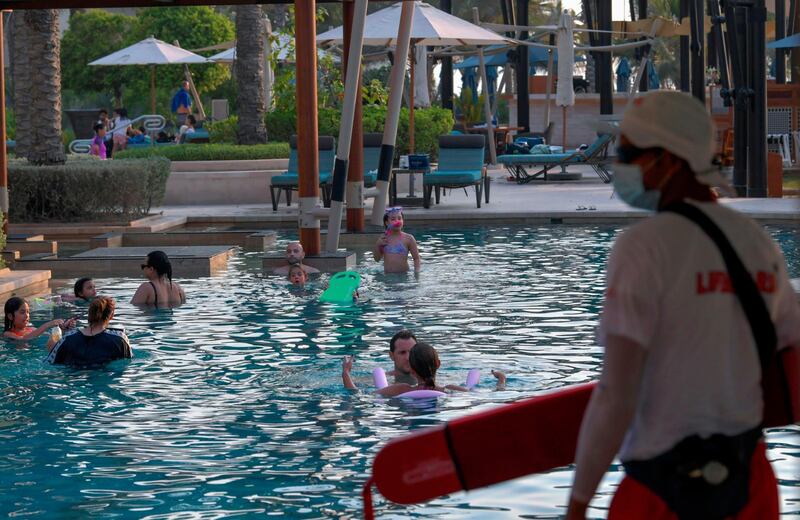 A lifeguard keeps watch as tourists swim. AFP