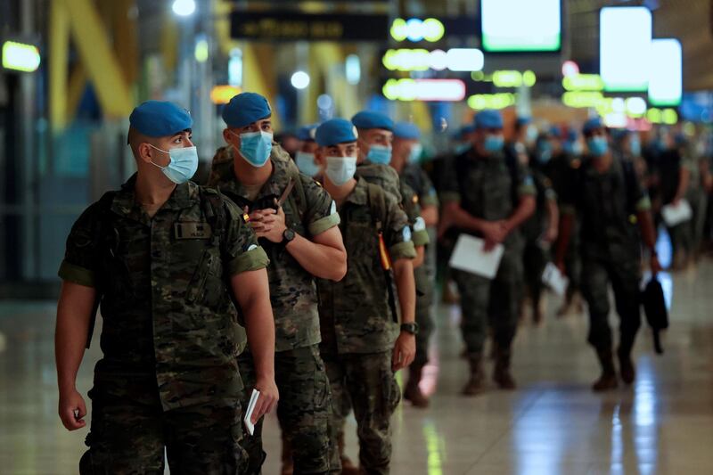 Spanish soldiers deployed to the United Nations Interim Force in Lebanon (UNIFIL) wear face masks as they prepare to travel to Lebanon following six months of training and two weeks of quarantine at the Adolfo Suarez Madrid-Barajas International Airport in Madrid, Spain.  EPA