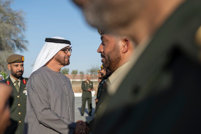President Sheikh Mohamed greets a member of the UAE Armed Forces during the ceremony at Abu Mreikhah