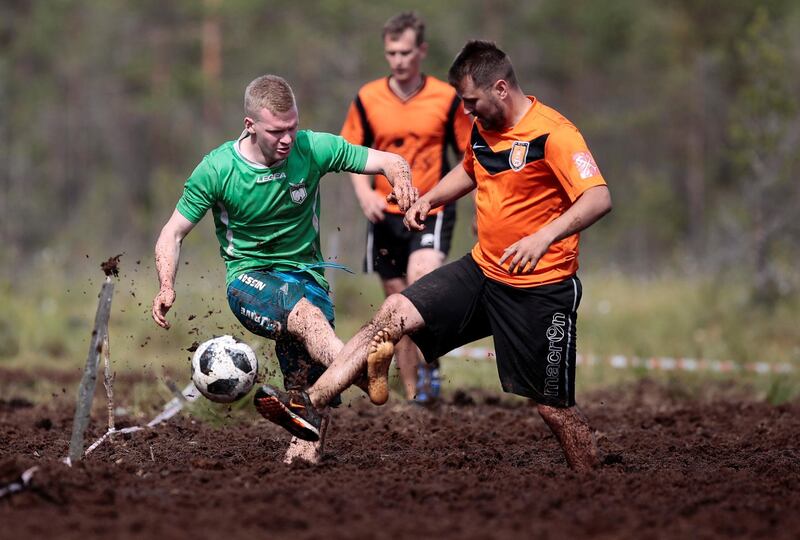 Members of Saint Petersburg Lakes and Pogi teams compete in the Swamp Football Cup of Russia in the village of Pogi in Leningrad Region, Russia June 16, 2018. Anton Vaganov / Reuters
