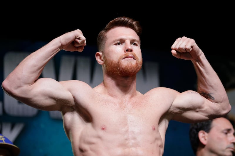 FILE - In this Sept. 15, 2017 file photo, Canelo Alvarez poses on the scale during a weigh-in, in Las Vegas. It was announced Monday, March 5, 2018, that Alvarez has tested positive for the banned drug clenbuterol, and promoters of his rematch with Gennady Golovkin blame contaminated meat. Alvarez's test showed traces of the drug. The director of the testing lab said the amount was consistent with meat contamination. (AP Photo/John Locher, File)