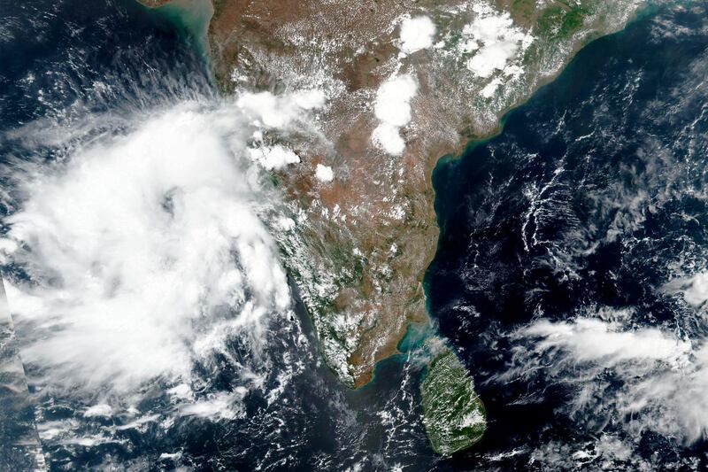 This May 31, 2020, satellite image released by NASA shows Cyclone Nisarga roaring toward the western coast of India. Indian Meteorological Department (IMD) authorities say that the cyclone brewing in the Arabian sea is expected to cross very close to India's western coast on Wednesday, June 3, 2020. Maharashtra and Gujarat states are on pre-cyclone alert as heavy rainfall is expected in the region. The city of Mumbai, already overwhelmed with the high incidence of coronavirus cases, is bracing for this unusual cyclone that may inundate low-lying slum areas. (NASA Worldview, Earth Observing System Data and Information System (EOSDIS) via AP)