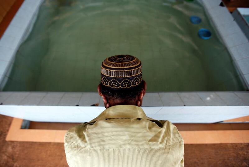 A man washes his face before afternoon prayers at a mosque in Kalutara, Sri Lanka. Dinuka Liyanawatte / Reuters