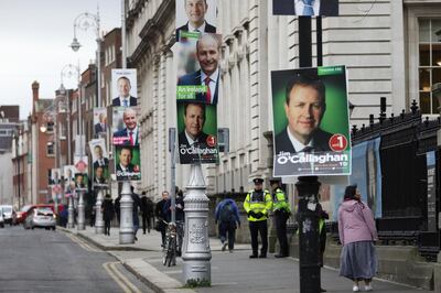 Election posters are displayed on lampposts outside the Irish Prime Minister offices in Dublin, Ireland, Friday, Feb. 7, 2020. Irish voters will choose a new parliament on Saturday, and may have bad news for the two parties that have dominated the countryâ€™s politics for a century, Fianna Fail and Fine Gael. Polls show a surprise surge for Sinn Fein, the party historically linked to the Irish Republican Army and its violent struggle for a united Ireland. (AP Photo/Peter Morrison)