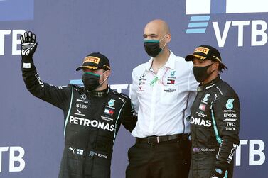 Mercedes' Valtteri Bottas, left, poses on the podium after winning the Russian Grand Prix alongside third placed Lewis Hamilton. Reuters