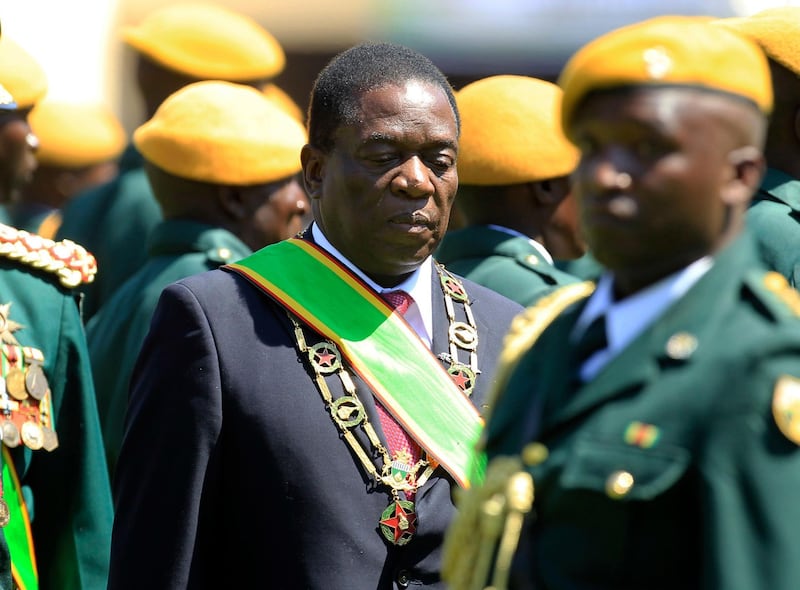 Zimbabwean President Emmerson Mnangagwa inspects the guard of honour during his inauguration ceremony at the National Sports Stadium in Harare, Sunday, Aug. 26, 2018. Zimbabwe on Sunday inaugurated a president for the second time in nine months as a country recently jubilant over the fall of longtime leader Robert Mugabe is now largely subdued by renewed harassment of the opposition and a bitterly disputed election. (AP Photo/Tsvangirayi Mukwazhi)