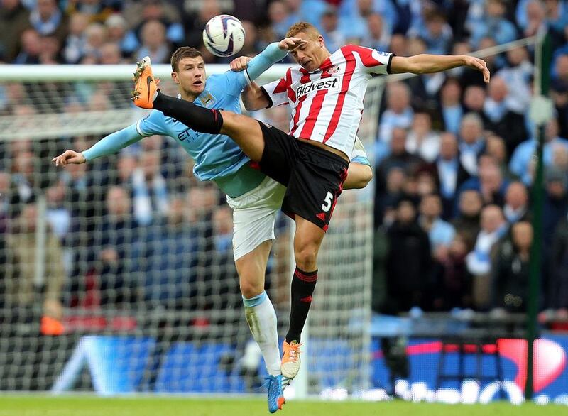 Sunderland's Wes Brown, right, vies for the ball with Manchester City's Edin Dzeko, left, during their English League Cup final soccer match at Wembley Stadium on March 2, 2014. Scott Heppell / AP