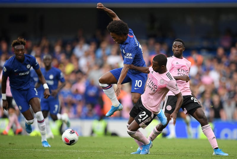 Willian looks to hold of Leicester's Portuguese defender Ricardo Pereira. AFP