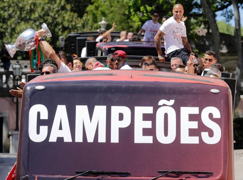 Portugal’s national football team members parade on a bus on its way to the Presidential Palace as they celebrate their victory  on July 11, 2016 after their Euro 2016 final football win over France yesterday. The Portuguese football team led by Cristiano Ronaldo returned home to a heroes’ welcome today after their upset 1-0 win triumph over France in the Euro 2016 final. AFP / JOSE MANUEL RIBEIRO