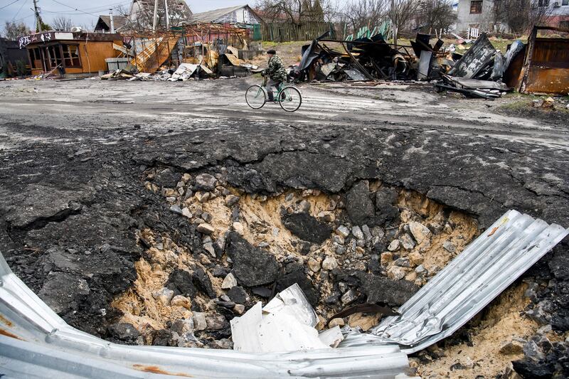 A bomb crater left behind by Russia's attack on the Ukrainian village of Demydiv, on the outskirts of Kyiv. Reuters
