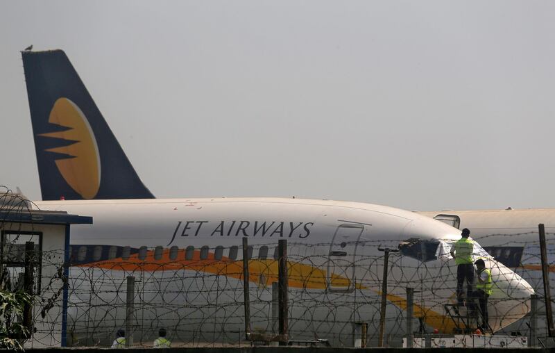 FILE PHOTO: Workers cover the cockpit window of a Jet Airways aircraft parked at the Chhatrapati Shivaji Maharaj International Airport in Mumbai, India, March 26, 2019. REUTERS/Francis Mascarenhas/File Photo